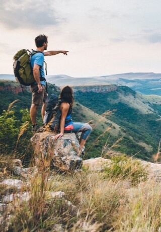 Two people looking out at mountain range