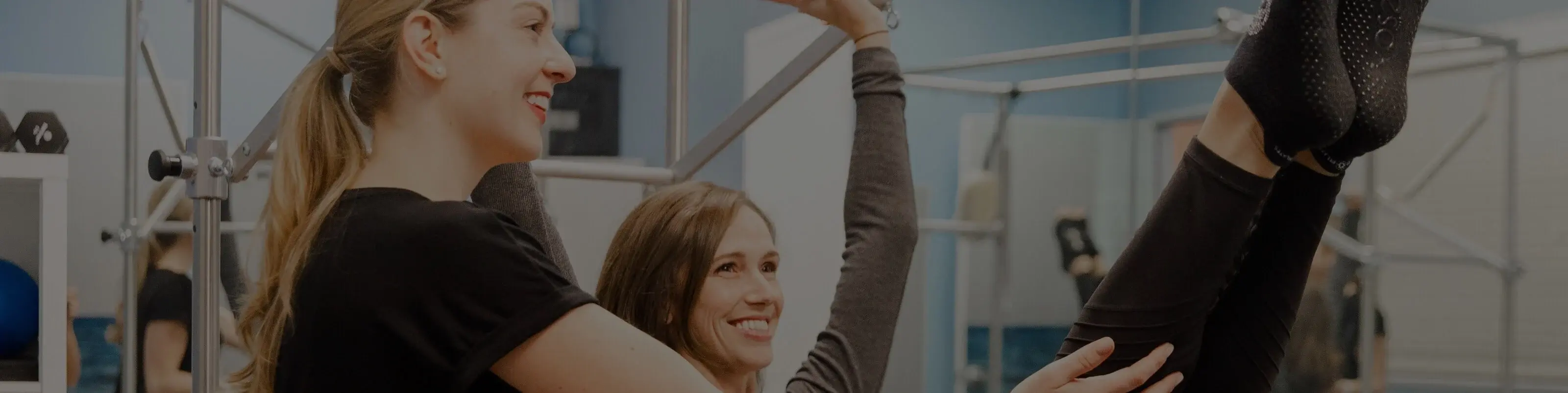 Club Pilates instructor guiding person who is exercising